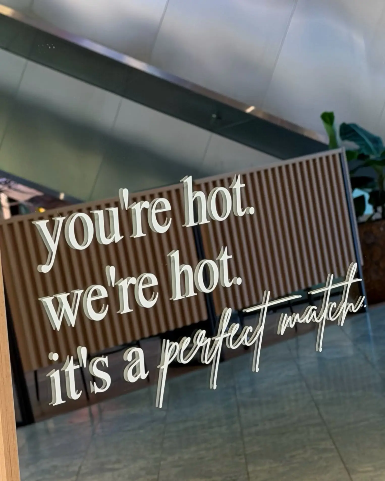 Leuchtschrift an der Wand: you’re hot. we’re hot. it’s a perfect match